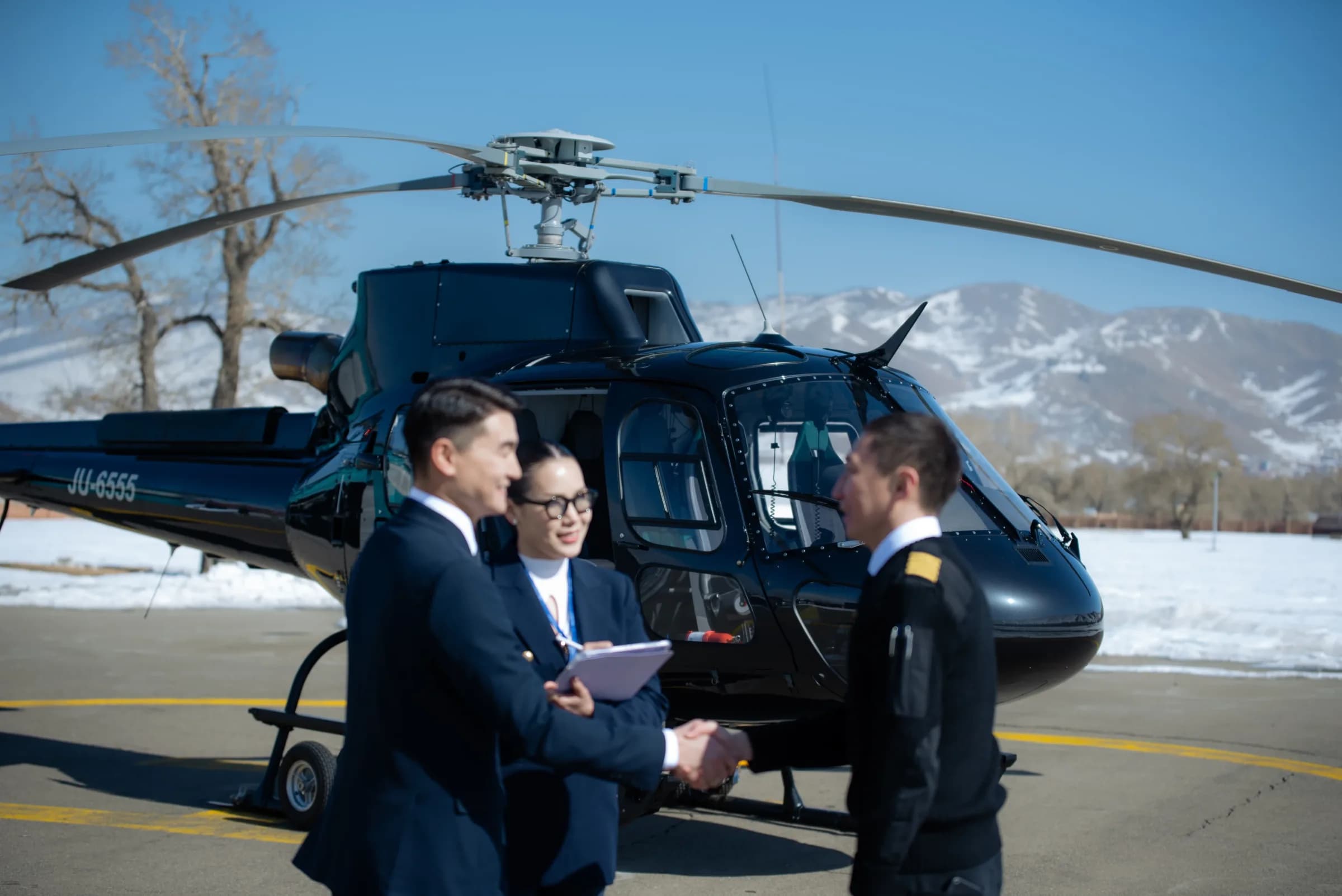 Insurco corporate team meeting beside a helicopter on the apron